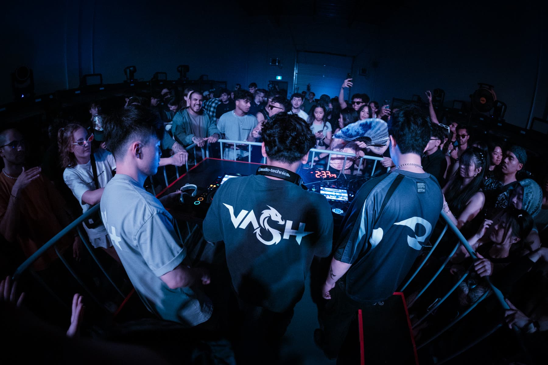 Guests pressed around the DJ booth on a busy floor