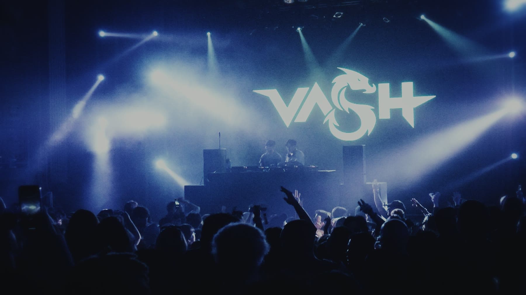 Beams fanning out above a crowd toward a lit screen